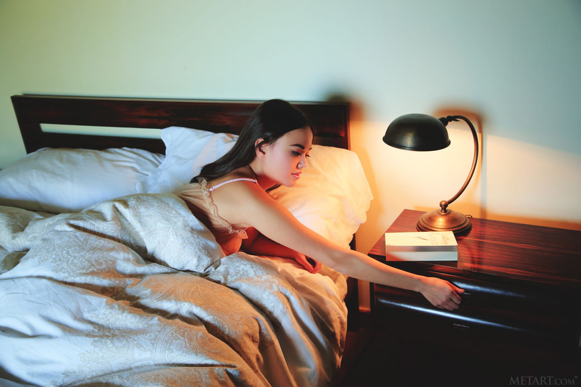 Petite, bespectacled beauty Li Moon reads a book in bed 2